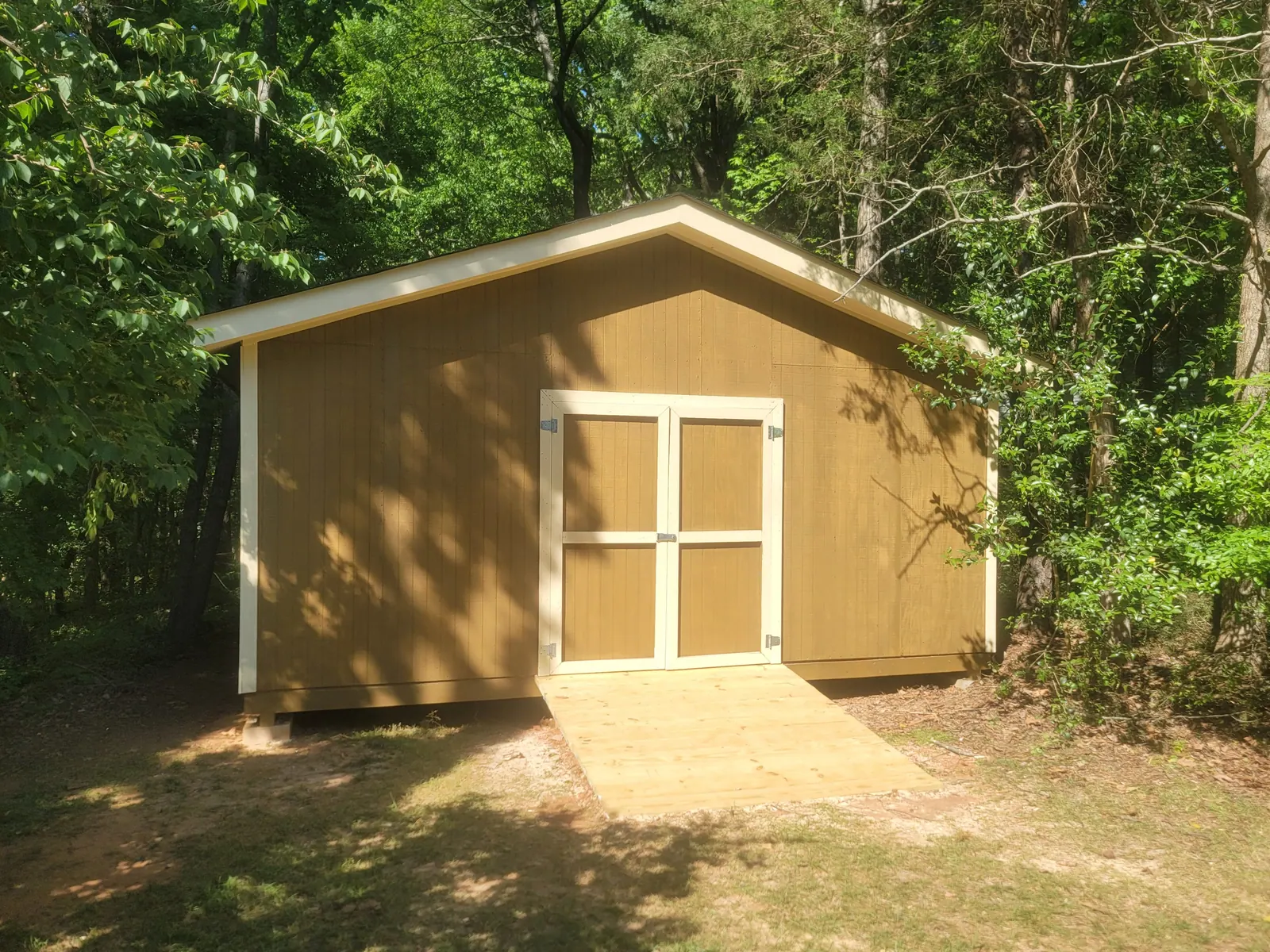 Finished backyard storage shed with double doors